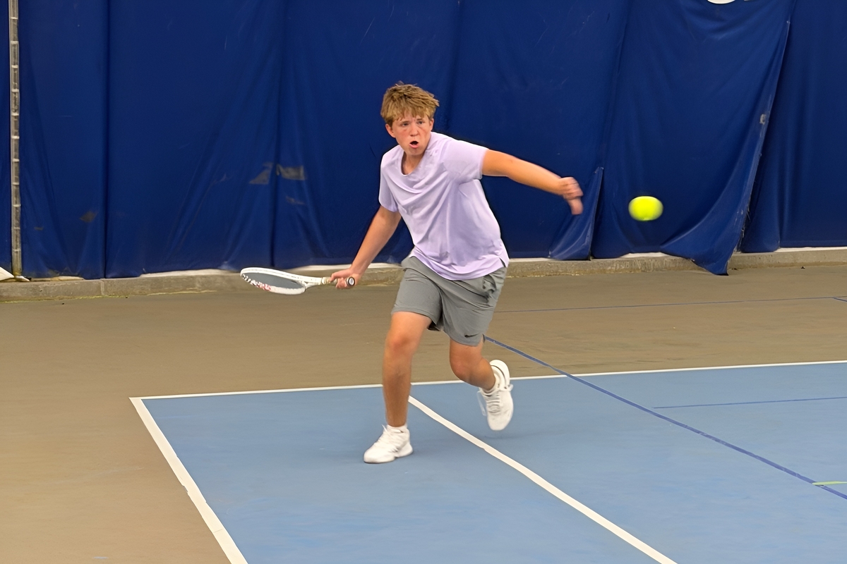 Junior player hitting a forehand at Junction Indoor Tennis Center