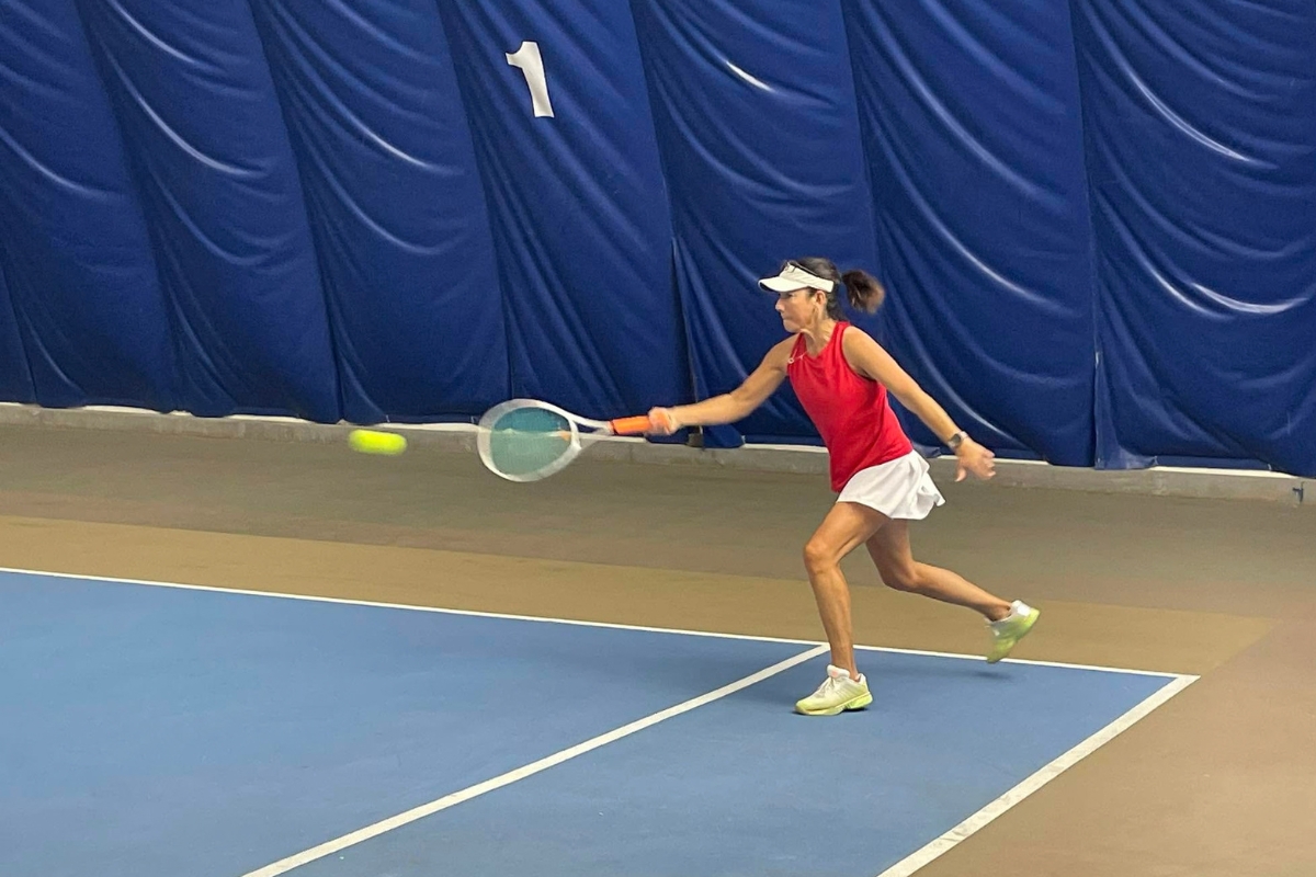 Adult player hitting a forehand at Junction Indoor Tennis Center